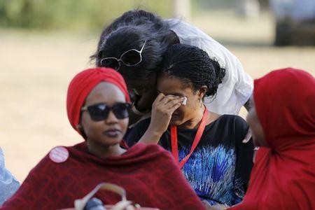 A woman is consoled while a Nigerian protest group continues their sit-in about the girls that are still missing from Chibok, in Abuja, Nigeria, April 29, 2015. PHOTO BY REUTERS/Afolabi Sotunde