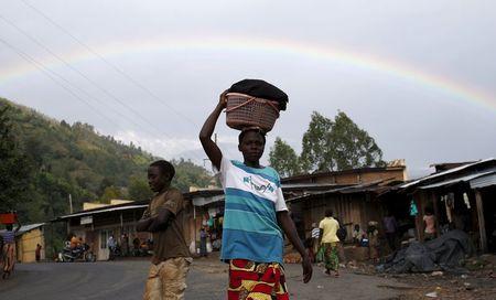 A woman walks in front of a rainbow in a village near Bujumbura, June 1, 2015. PHOTO BY REUTERS/Goran Tomasevic