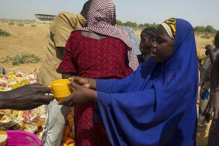 A Nigerian woman who returned from Niger receives a cup of tea at a registration centre at Geidam stadium, Nigeria May 6, 2015. REUTERS/Afolabi Sotunde