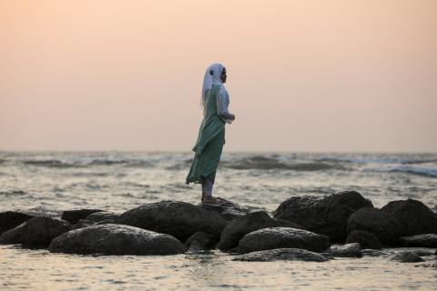 A woman watches sunset on a beach near Cox's Bazar, Bangladesh, December 15, 2017. PHOTO BY REUTERS/Marko Djurica