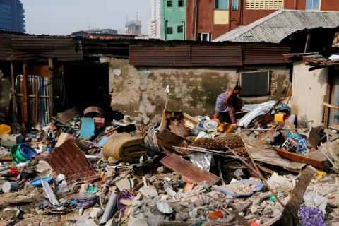 A woman searches for belongings at the site of a collapsed building in Nigeria's commercial capital of Lagos, Nigeria, March 14, 2019. PHOTO BY REUTERS/Afolabi Sotunde