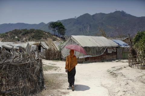 A Rohingya woman walks at the Kyein Ni Pyin camp for internally displaced people in Pauk Taw, Rakhine state