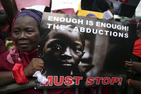 A woman holds a sign during a protest demanding the release of secondary school girls abducted from the remote village of Chibok, in Lagos