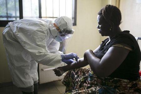 A health worker attends to a patient at the maternity ward in the government hospital in Koidu, Kono district in eastern Sierra Leone, December 20, 2014. PHOTO BY REUTERS/Baz Ratner