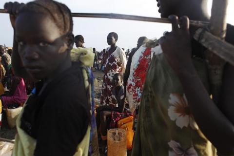 Women displaced by the fighting wait to get clean water at a water point in a camp for internally displaced persons (IDPs) at the United Nations (UN) base in Bentiu, Unity State