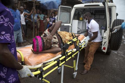 A pregnant woman suspected of contracting Ebola is lifted by stretcher into an ambulance in Freetown, Sierra Leone