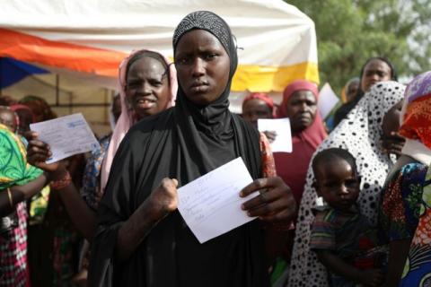 A woman, with a hand cut off, is seen with a food ration card in a queue to receive food supplement from World Food Programme (WFP) at the Banki IDP camp, Borno, Nigeria, April 26, 2017. PHOTO BY  REUTERS/Afolabi Sotunde