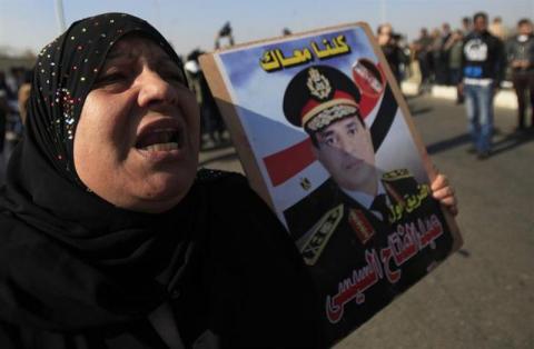 A supporter of Egypt's army chief Field Marshal Abdel Fattah al-Sisi shouts slogans during a demonstration outside a police academy, where the trial of ousted Egyptian President Mohamed Mursi and members of the Muslim Brotherhood is held