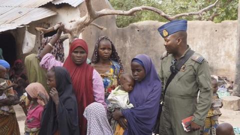 A soldier from the Nigerian Army talks with hostage women and children who were freed from Boko Haram, in Yola, in this April 29, 2015. PHOTO BY REUTERS/Nigerian Military