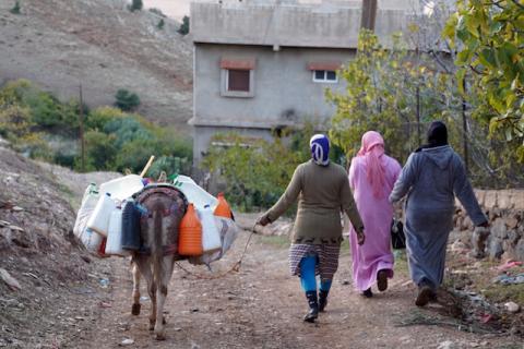 Three women walk with their donkey carrying plastic containers of water to their homes in the community of Ait Hammou Ouhmad on the edge of Azrou in Morocco, November 6, 2019. PHOTO BY REUTERS/Abdelhak Balhaki