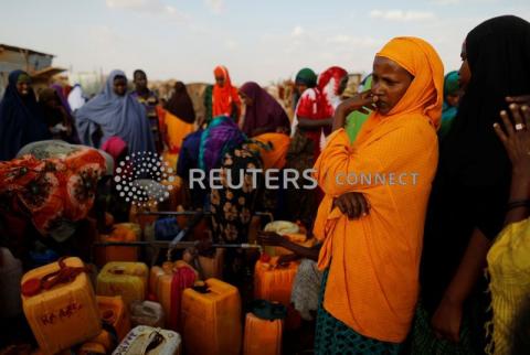 Displaced women from drought hit areas wait to fill their jerrycans as they gather at the water point at a camp for internally displaced people in Dollow, Somalia, April 3, 2017. PHOTO BY REUTERS/Zohra Bensemra