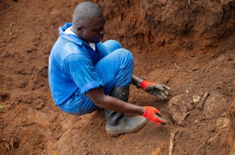 A Burundian worker from the Truth and Reconciliation Commission extracts the skull of an unidentified person from a mass grave in the Bukirasazi hill in Karusi Province, Burundi, January 27, 2020. PHOTO BY REUTERS/Evrard Ngendakumana