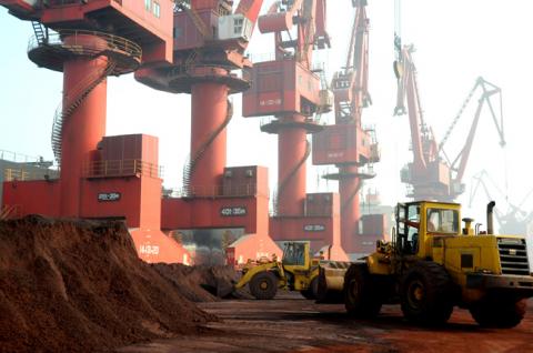 Workers transport soil containing rare earth elements for export at a port in Lianyungang, Jiangsu province, China, October 31, 2010. PHOTO BY REUTERS/Stringer