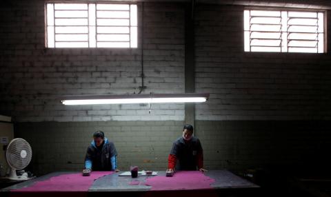 Brazilian workers give a colour on a piece of leather which will be used as leather to make shoes during a shoe-making process at a factory in Novo Hamburgo in the state of Rio Grande do Sul, August 5, 2010. PHOTO BY REUTERS/Nacho Doce