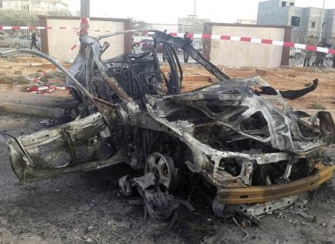 The wreckage of a car is pictured after a bomb exploded outside the Ajdabiya's Security Directorate headquarters, December 1, 2014. PHOTO BY REUTERS/Stringer