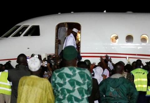 Former Gambian President Yahya Jammeh boards a plane at the airport as he flying into exile from Gambia. PHOTO BY REUTERS/Thierry Gouegnon