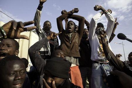 Members of Senegalese anti-government youth movement Y'En A Marre, or "We're Fed Up," chant slogans in Senegal's capital Dakar, February 16, 2012. PHOTO BY REUTERS/Joe Penney