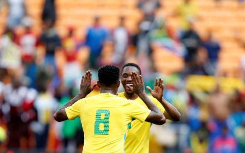 South Africa's Bongani Zungu congratulates Sibusiso Vilakazi. PHOTO BY REUTERS/Siphiwe Sibeko