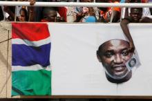 A supporter of Gambia President Adama Barrow waves a ECOWAS flag during his swearing-in ceremony and the Gambia's Independence day at Independence Stadium, in Bakau, Gambia, February 18, 2017. PHOTO BY REUTERS/Thierry Gouegnon