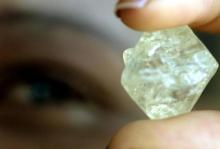 A worker at the Botswana Diamond Valuing Company displays a rough diamond during the sorting process at the purpose-built centre in the capital Gaborone. PHOTO BY REUTERS