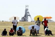Miners outside the Impala platinum mine in Rustenburg, 120 km (75 miles) northwest of Johannesburg. PHOTO BY REUTERS/Siphiwe Sibeko