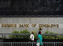 People walk past the Reserve Bank of Zimbabwe building in Harare, Zimbabwe, February 25, 2019. PHOTO BY REUTERS/Philimon Bulawayo