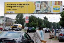 People stand near an advertising billboard for MTN telecommunication company along a street in Abuja, Nigeria, September 4, 2018. PHOTO BY REUTERS/Afolabi Sotunde