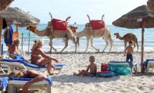Tourists relax on a beach on the island of Djerba, Tunisia, September 7, 2016. PHOTO BY REUTERS/Zoubeir Souissi