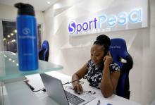 A worker at the Sportpesa, online sports betting firm, attends to a telephone at the company headquarters in Nairobi, Kenya, January 3, 2018. PHOTO BY REUTERS/Thomas Mukoya