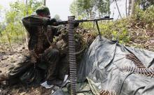 A Congolese army fighter takes position to guard against the M23 rebels in Kibati village