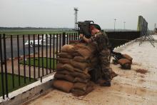 A French soldier conducts reconnaissance on the roof of the Mpoko airport in Bangui