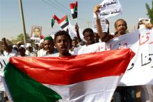 A man holds a Sudanese flag as he chants slogans against the government's deadly crackdown on people protesting against subsidy cuts late last month