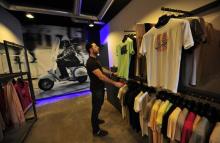 A shop assistant inspects a shirt rack in the popular clothing store Boza in Benghazi