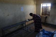 A woman votes in a polling station located in a school during a referendum in the town of Abyei 