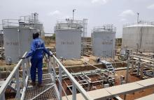 A worker walks at the power plant of an oil processing facility at an oilfield in Unity State