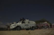 African Mission in Somalia (AMISOM) soldiers rest on top of an armoured vehicle during a break on a night joint street patrol with local police at the old stadium in Mogadishu, Somalia, November 14, 2013. PHOTO BY REUTERS/Siegfried Modola