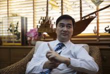 Thailand's opposition leader and former Prime Minister Abhisit Vejjajiva gestures during an interview with foreign media at his Democrat Party headquarters in Bangkok