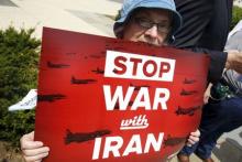 An activist holds a banner during an event of delivering more than 400,000 petition signatures to Capitol Hill in support of the Iran nuclear deal in Washington, July 29, 2015. PHOTO BY REUTERS/Yuri Gripas