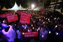 People light candles during a street concert organized to highlight the situation in Burundi by PAWA254, an activist organization, in Kenya's capital Nairobi, December 20, 2015. PHOTO BY REUTERS/Noor Khamis