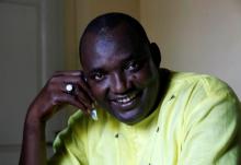 The new president of Gambia, Adama Barrow smiles as he makes a call at his home in Yarambamba, West Coast Region, Gambia, December 3, 2016. PHOTO BY REUTERS/ Thierry Gouegnon