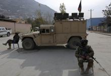 Afghan National Army (ANA) soldiers keep watch near a building in which the Loya Jirga (or grand council) is holding a committee session, in Kabul