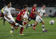 Guangzhou Evergrande's Huang Bowen (2nd L) fights for the ball with Bayern Munich's Thiago during their FIFA Club World Cup soccer match at Agadir Stadium in Agadir