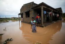 Agiro Cavanda and his wife Agera wade through floodwaters outside their home, flooded in the aftermath of Cyclone Kenneth, at Wimbe village in Pemba, Mozambique, April 29, 2019. PHOTO BY REUTERS/Mike Hutchings