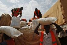 Aid workers unload food to be distributed at a camp for people displaced by the recent unrest, at the Mpoko international airport of Bangui, February 12, 2014. PHOTO BY REUTERS/Luc Gnago