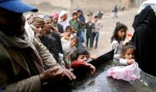 People queue to collect food rations at a food distribution center in Sanaa, Yemen, March 21, 2017. PHOTO BY REUTERS/Khaled Abdullah