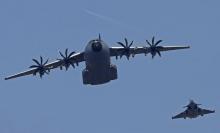 An Airbus A400M military aircraft and a military fighter jet fly over the Champs Elysees as part of the traditional Bastille Day parade in Paris, July 14, 2013. PHOTO BY REUTERS/Christian Hartmann