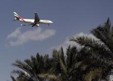 An Emirates Airlines aircraft lands at the Emirates terminal at Dubai International Airport