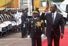 Ivory Coast's President Alassane Ouattara (R) salutes while walking next to Chief of Staff, General Soumaila Bakayoko during a parade to commemorate the country's 54th Independence Day, outside the presidential palace in Abidjan, August 7, 2014. PHOTO BY REUTERS/Luc Gnago