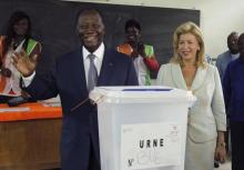 Ivory Coast's President Alassane Ouattara of the Rally of the Houphouetists for Democracy and Peace (RHDP) party smiles next to his wife Dominique after casting his vote at a polling station during a presidential election in Abidjan, Ivory Coast, October 25, 2015. PHOTO BY REUTERS/Luc Gnago