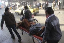 People carry a wounded man on a stretcher after what activists said was an air raid by forces loyal to Syrian President Bashar Al-Assad, at Masaken Hanano in Aleppo